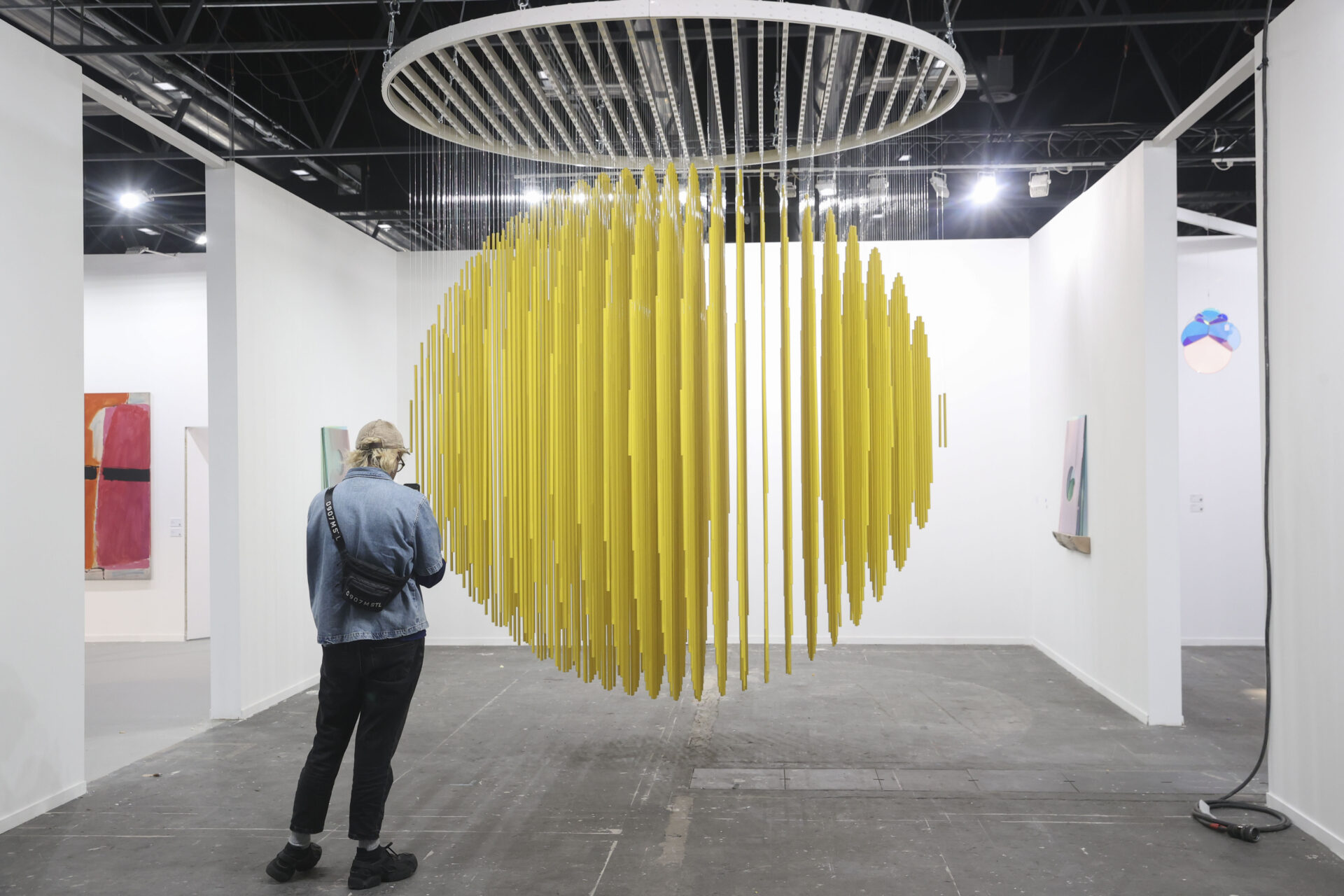 Una mujer observa la obra Esfera Amarilla 1984, del artista Jesús R. Soto en la Galería Elvira González, expuesta en la Feria Internacional de Arte Contemporáneo de España ARCO 2026