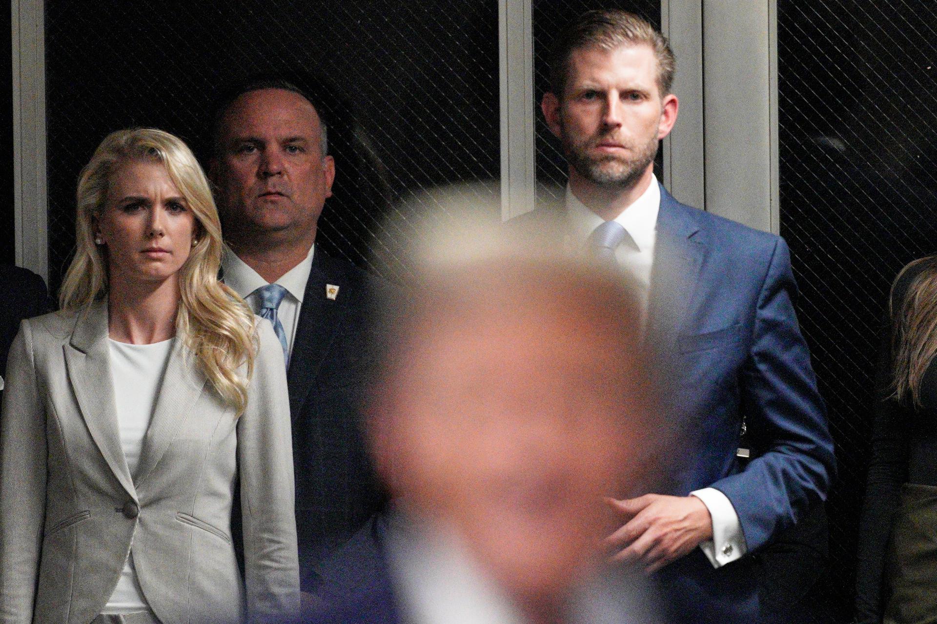New York (United States), 30/04/2024.- Natalie Harp (L) and Eric Trump (R) listen as former US President Donald Trump talks with the press reporters as he leaves the courtroom at the end of the day in his criminal trial at New York State Supreme Court in New York, New York, USA, 30 April 2024. Trump is facing 34 felony counts of falsifying business records related to payments made to adult film star Stormy Daniels during his 2016 presidential campaign. (tormenta, Nueva York) EFE/EPA/CURTIS MEANS / POOL