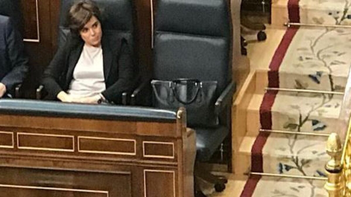 Soraya Sáenz de Santamaría sentada en el Congreso de los Diputados junto a su bolso