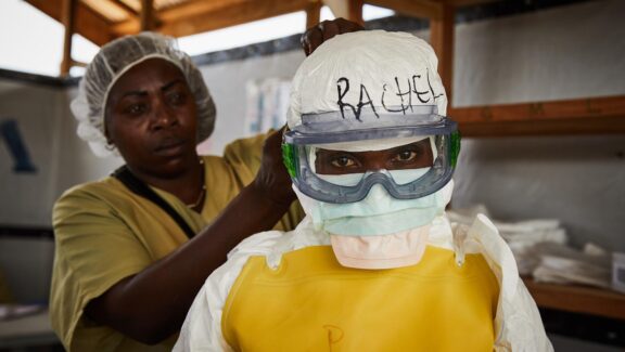 BENI (Congo, the Democratic Republic of the), 12/05/2026.- (FILE) - Rachel Rukwati suits up in PPE to enter a high-risk treatment zone, at the peak of the Ebola crisis, at a health centre in Beni, North Kivu, Democratic Republic of Congo, 04 May 2019 (reissued 12 May 2026). International Nurses Day (IND) is celebrated annually on 12 May to mark the birth of Florence Nightingale, founder of modern nursing. The day honours the vital contributions nurses make to global healthcare and societies. (Florencia) EFE/EPA/HUGH KINSELLA CUNNINGHAM