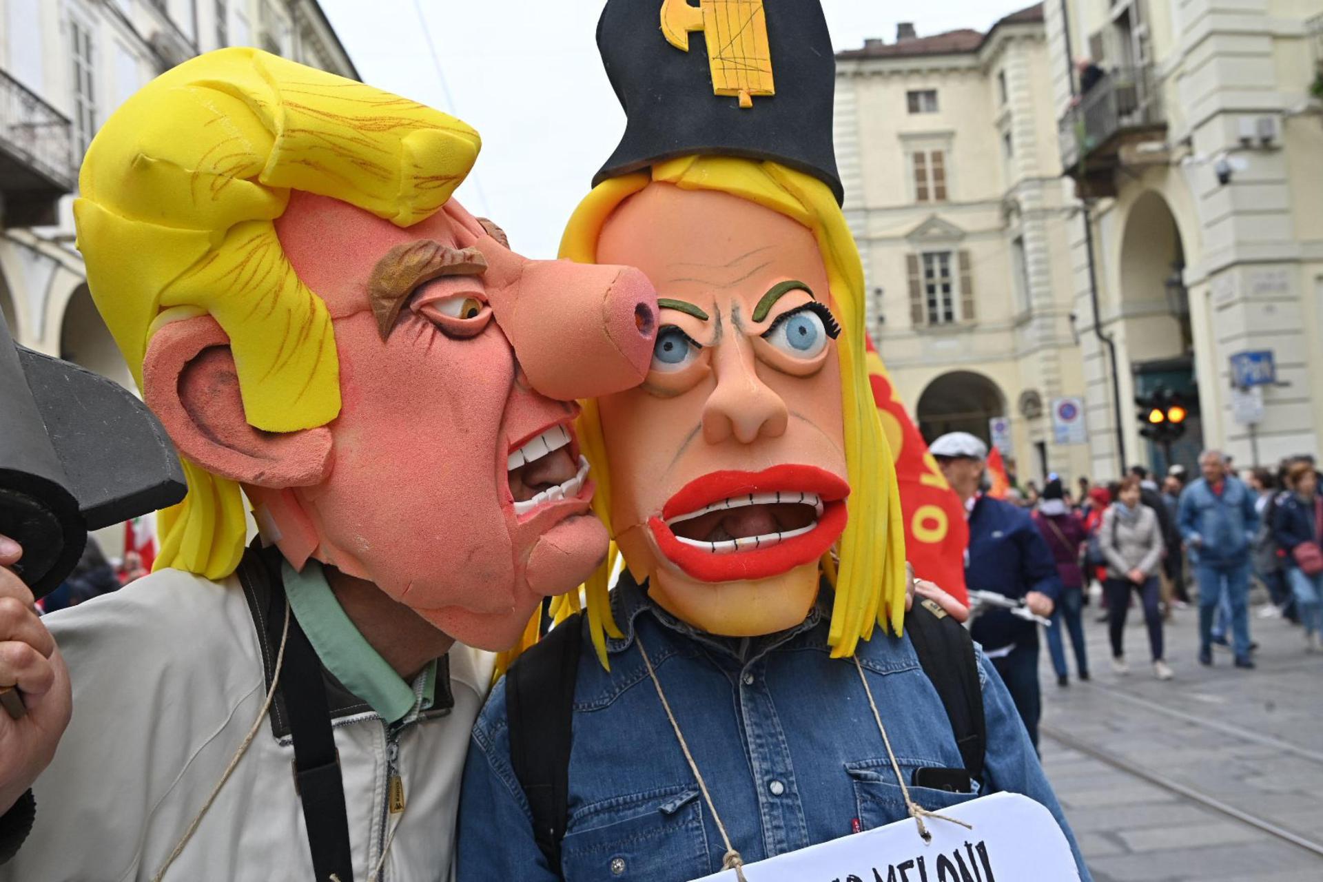 TURIN (Italy), 01/05/2026.- People wearing Italian Prime minister Meloni and US President Trump masks take part in a rally to mark Labor Day in Turin, Italy, 01 May 2026. (Italia) EFE/EPA/ALESSANDRO DI MARCO
