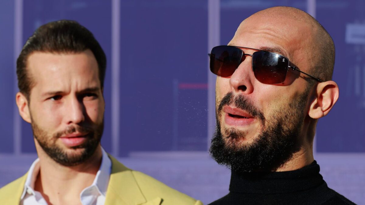 El ex kickboxer profesional e influencer de redes sociales Andrew Tate (derecha), respaldado por su hermano Tristan (izquierda), hace gestos mientras se burla de los periodistas tras una audiencia sobre la devolución de bienes confiscados en el Tribunal de Bucarest.