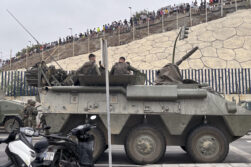 El ejército desplegando en la frontera del Tarajal en Ceuta ante la atenta mirada de los inmigrantes este viernes, donde se han registrado violentos enfrentamientos en los perímetros fronterizos durante su intento de acceder desde Marruecos hacia Ceuta y Melilla. EFE/ Reduan Dris