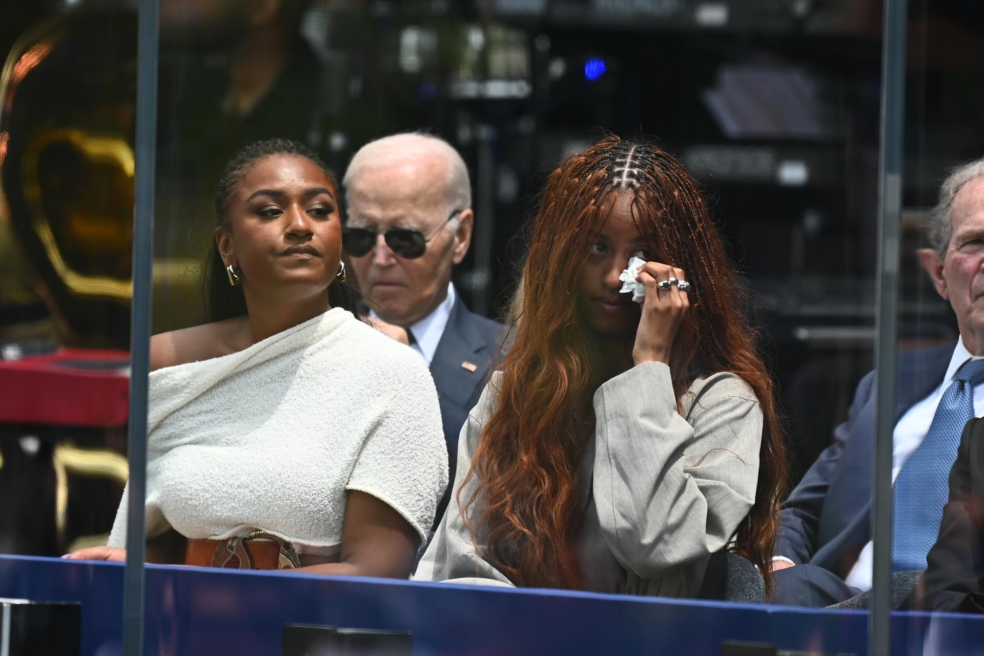 Malia Obama and her sister Sasha Obama watch their mother speak during the opening ceremony of the Obama Presidential Center in Chicago, Illinois, USA, 18 June 2026. The Obama Presidential Center in Chicago will serve as a civic hub, museum, library, and education project commemorating the presidency of Barack Obama. EFE/EPA/VICTOR HILITSKI