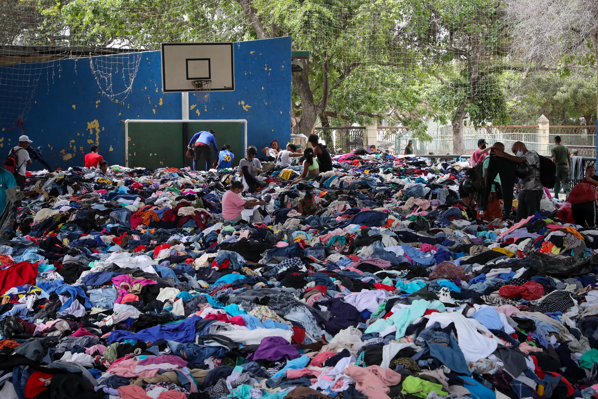 Personas seleccionan ropa este sábado, en La Guaira (Venezuela). Decenas de personas buscan, artículos de utilidad entre toneladas de ropa esparcidas en el suelo del polideportivo La Juanita, tras verse afectados por el doble terremoto del pasado 24 de junio. EFE/ Raúl Martínez