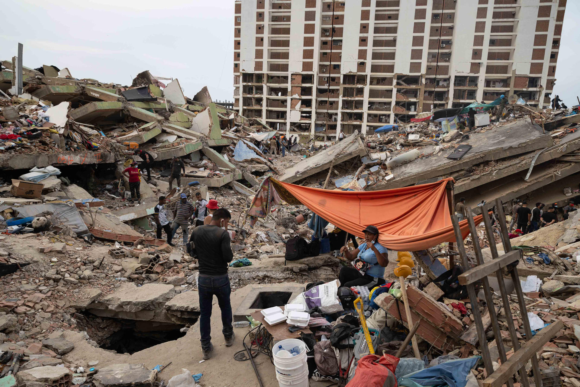 AME7749. LA GUAIRA (VENEZUELA), 05/07/2026.- Personas buscan entre los escombros este domingo, en La Guaira (Venezuela). La cifra de fallecidos por el doble terremoto del pasado 24 de junio en Venezuela aumentó a 3.342, mientras que la de heridos se elevó a 16.740, informó el presidente del Parlamento venezolano, Jorge Rodríguez. EFE/ Rayner Peña