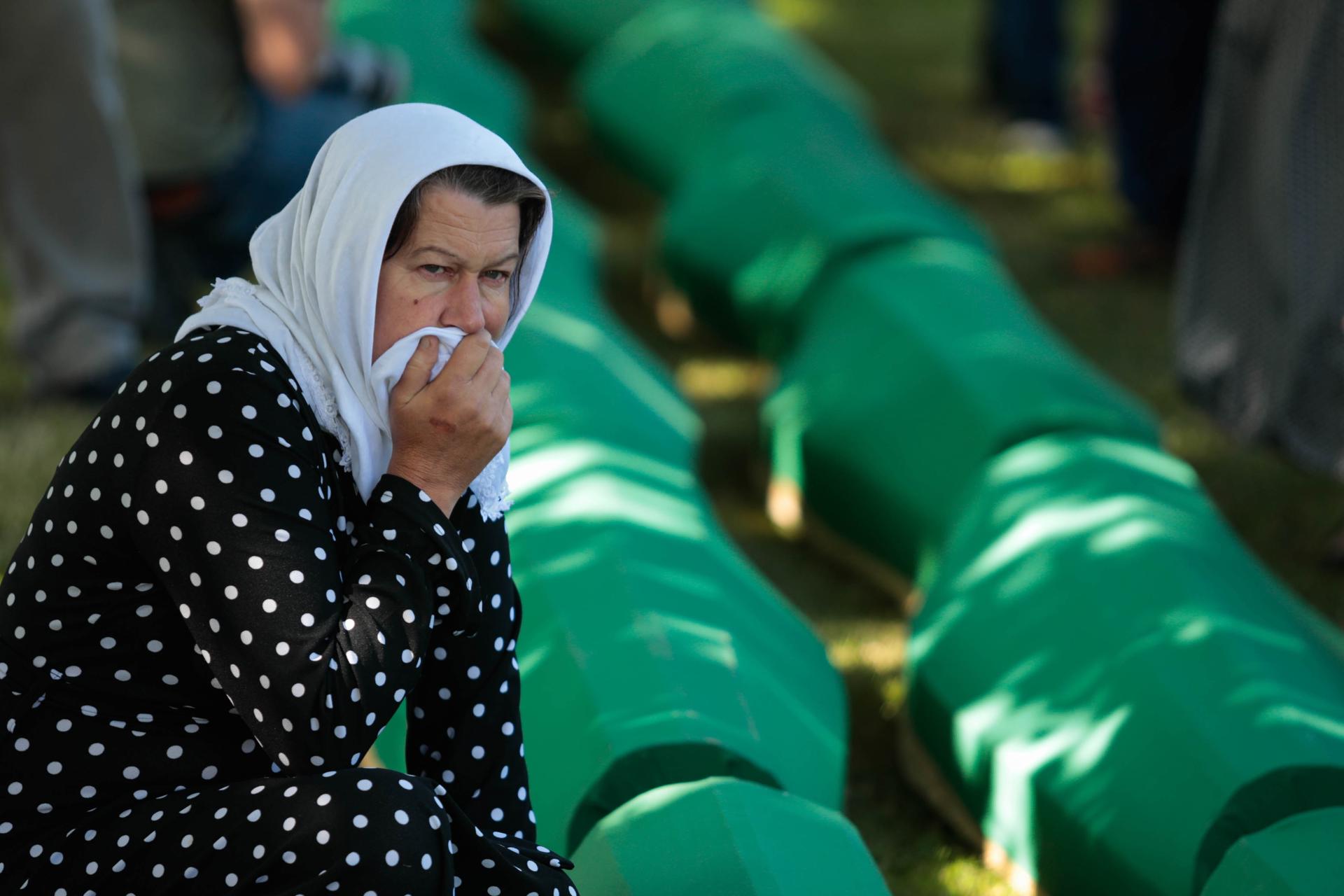 Srebrenica (Bosnia And Herzegovina), 11/07/2022.- A Bosnian Muslims woman mourns over caskets with remains during a funeral ceremony for fifty newly-identified Bosnian Muslim victims, at the Potocari Memorial Center and Cemetery in Srebrenica, Bosnia and Herzegovina, 11 July 2022. The burial was part of a memorial ceremony to mark the 27th anniversary of the Srebrenica genocide, considered the worst atrocity of Bosnia's 1992-95 war. More than 8,000 Muslim men and boys were executed in the 1995 killing spree after Bosnian Serb forces overran the town. (Bosnia-Herzegovina) EFE/EPA/JASMIN BRUTUS