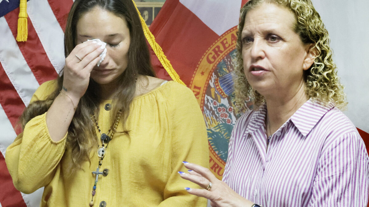 Claudia Carolina Rodriguez Caglianone of Davie, left, gets emotional as Congresswoman Debbie Wasserman Schultz talks about conditions at ICE facilities during a press conference in Sunrise on Tuesday, August 4, 2026. Claudia was detained for eight days at an ICE facility in Miramar. Carline Jean/South Florida Sun Sentinel)