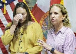Claudia Carolina Rodriguez Caglianone of Davie, left, gets emotional as Congresswoman Debbie Wasserman Schultz talks about conditions at ICE facilities during a press conference in Sunrise on Tuesday, August 4, 2026. Claudia was detained for eight days at an ICE facility in Miramar. Carline Jean/South Florida Sun Sentinel)