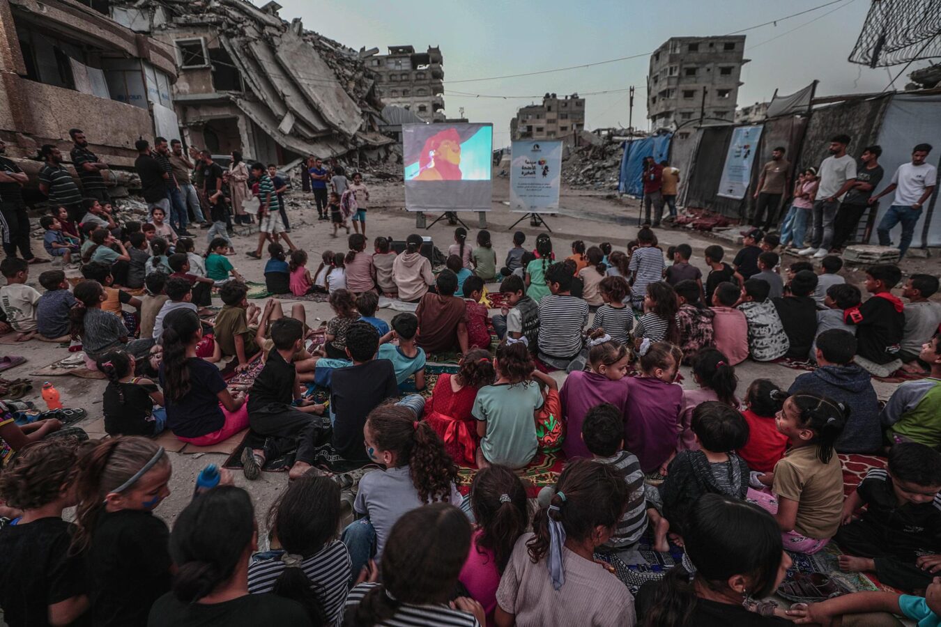 GAZA CITY (---), 16/10/2026.- Internally displaced Palestinian children watch a movie at a makeshift open-air cinema near the ruins of destroyed buildings in the Al-Sheikh Redwan neighborhood in Gaza City, 15 October 2026. Around 1.9 million people in Gaza, nearly 90 percent of the population, have been displaced since the Israel-Hamas conflict began in October 2023, according to the UN. (Cine) EFE/EPA/MOHAMMED SABER