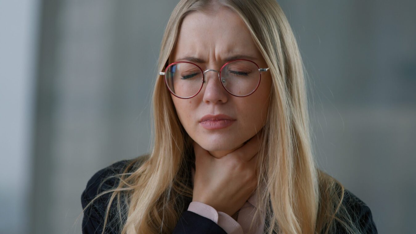 Mujer que sufre dolor de garganta.