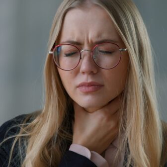 Mujer que sufre dolor de garganta.